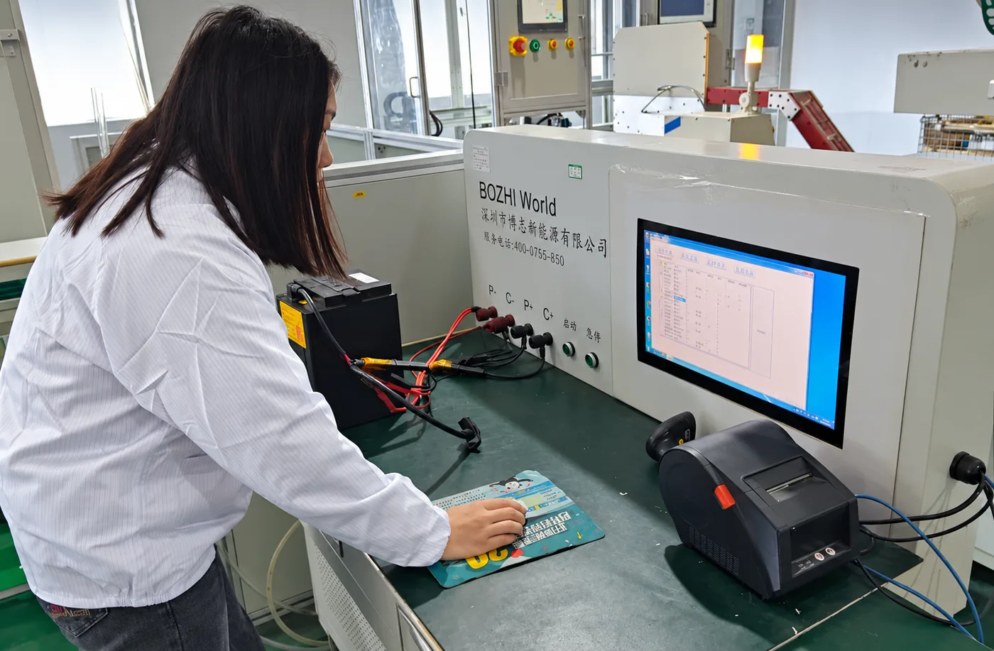 Technician testing a finished battery pack at an end-of-line test station